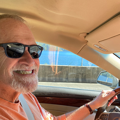 Michael King smiling while driving