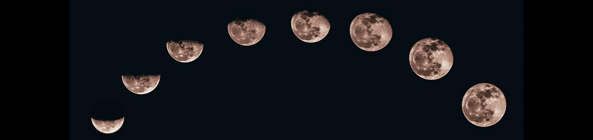 Moon phases across black background