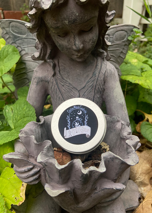 Bugs Be-Gone tin in fairy statue