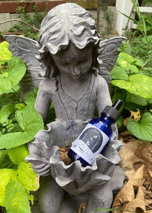 Happy Place blue tincture bottle in a fairy statue - front view