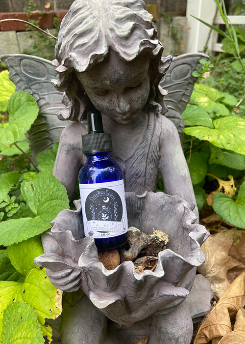 RememberAll tincture bottle on fairy statue.