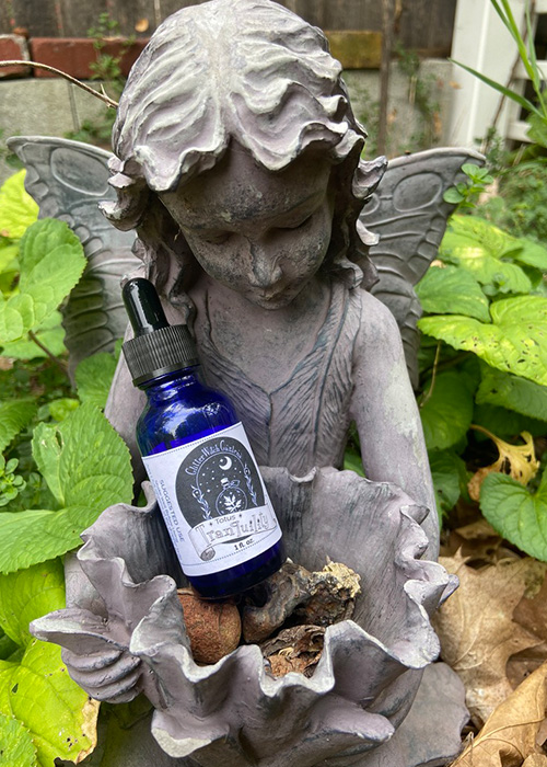Totus Tranquility blue tincture bottle in fairy statue